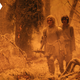 Galadriel walks across a burned landscape